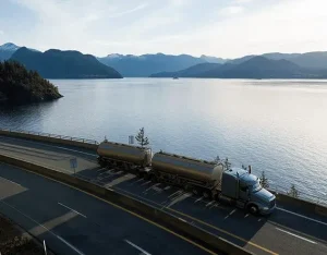 semi trailer hauling tanks on a road the water